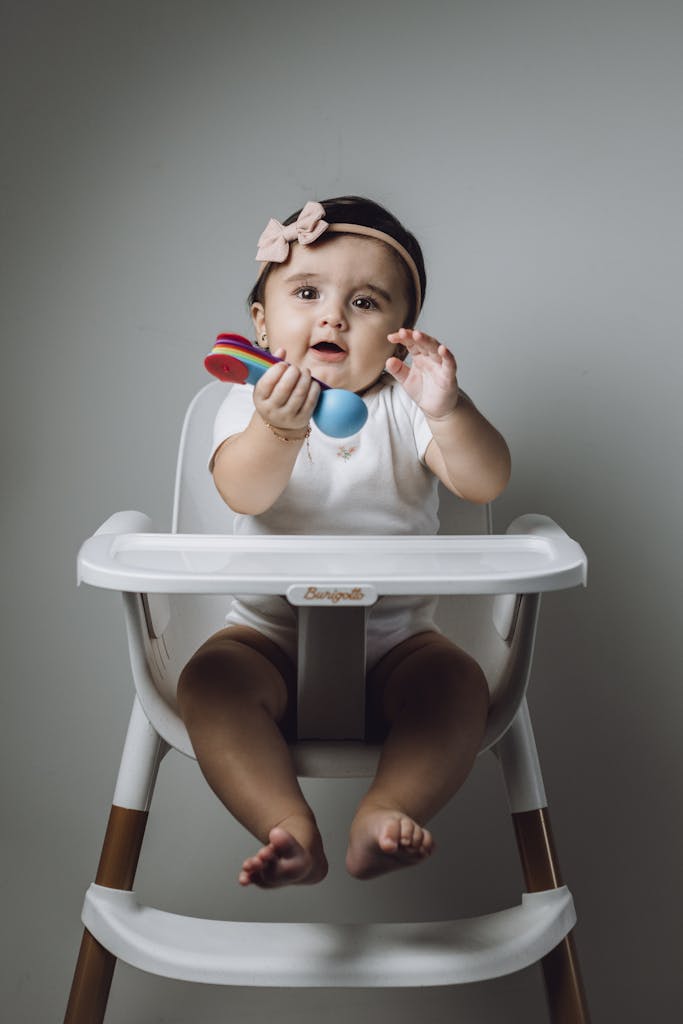 Girl Sitting on Baby Chair